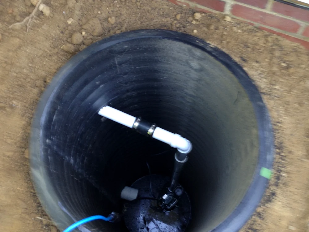 Sump pump basin and drainage connection by Sferra Waterproofing